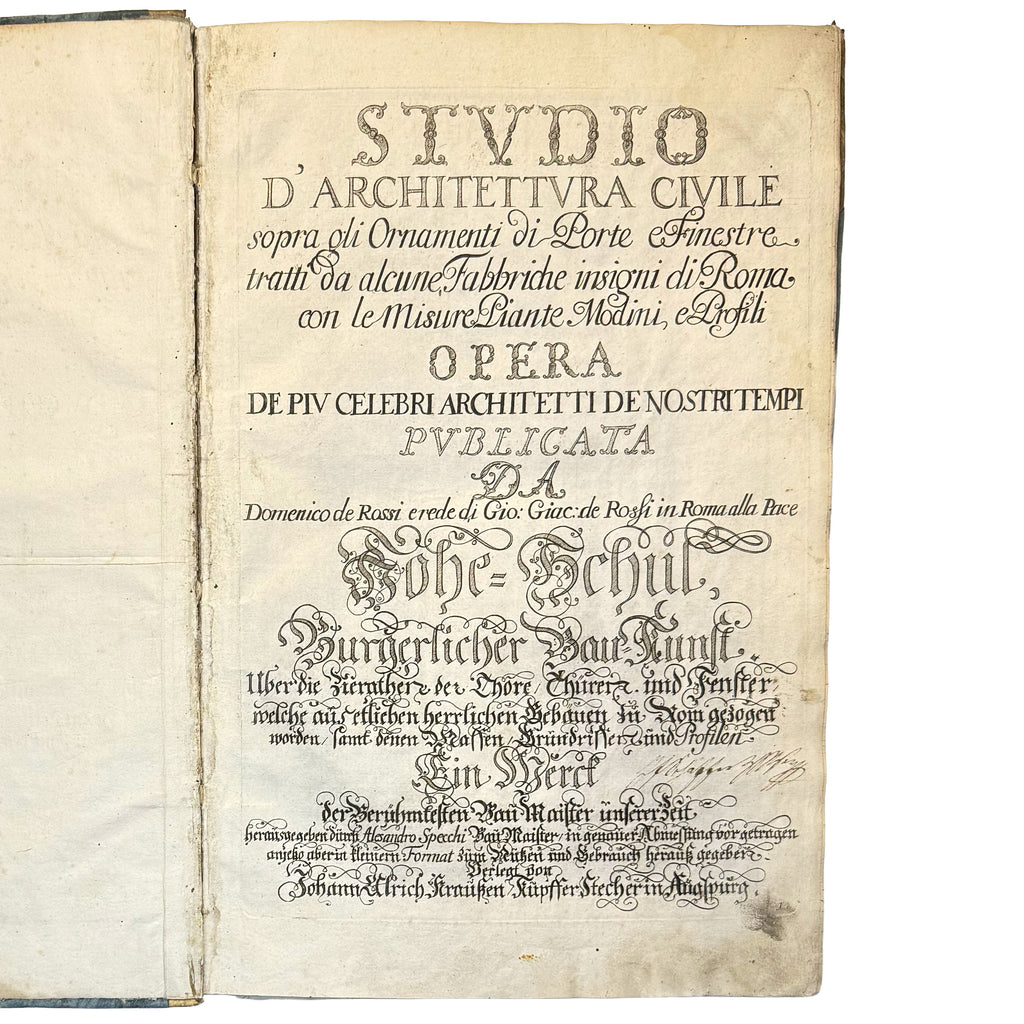 An open antique book showing a printed page in German with ornate typography and aged, yellowed paper on a plain white background.